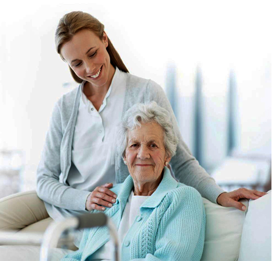 A caregiver standing with an older adult at home